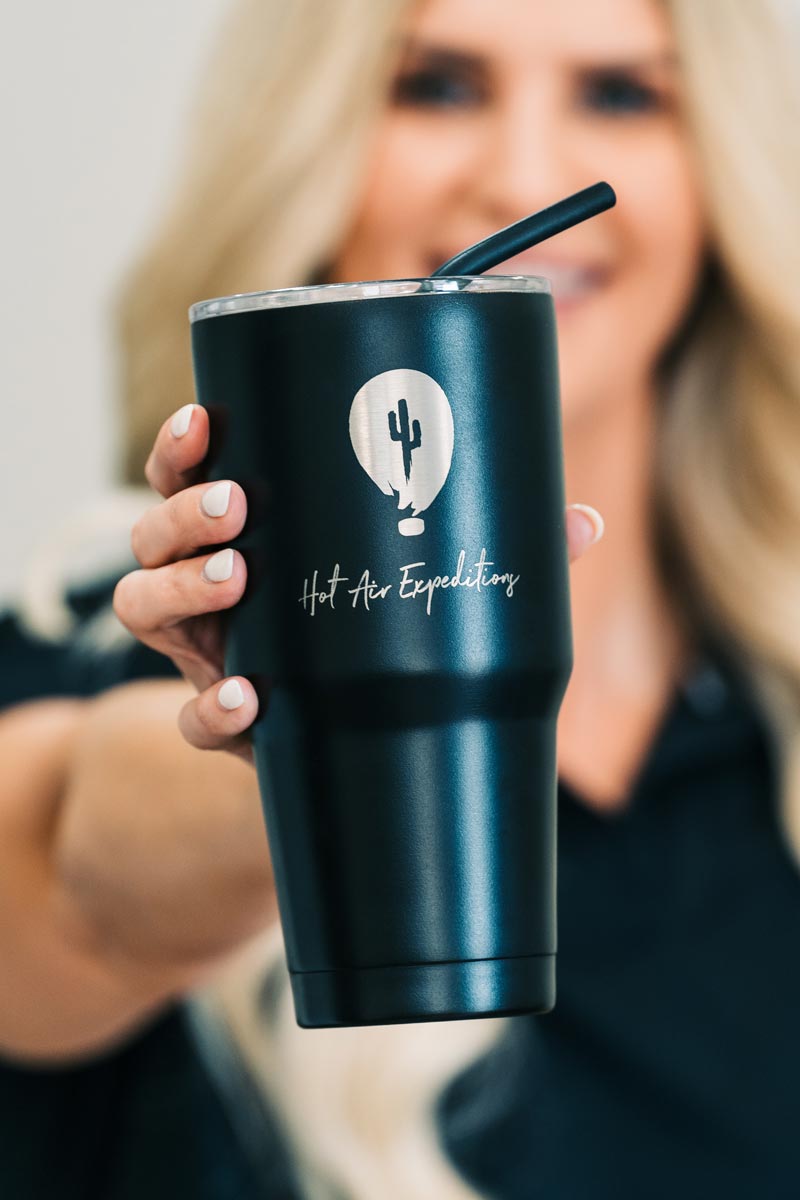 https://hotairexpeditions.com/wp-content/uploads/2022/08/hot-air-expeditions-matte-black-tumbler-in-hand.jpg